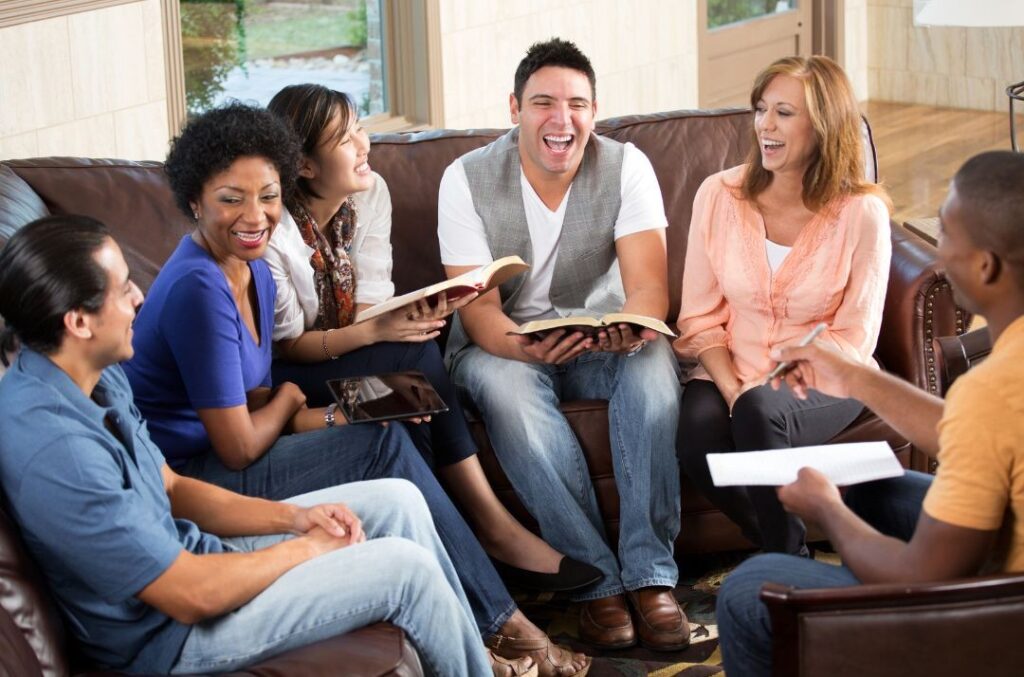 Small group of people sitting in a lounge doing Bible study